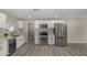 Bright kitchen featuring stainless steel appliances, white cabinetry, and stylish backsplash at 7906 W Catalina Dr, Phoenix, AZ 85033