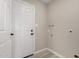 Mud room with white door, new flooring, and laundry hookups at 7906 W Catalina Dr, Phoenix, AZ 85033