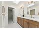 Bright bathroom featuring a double vanity with framed mirrors and a skylight at 8088 E Via Del Valle --, Scottsdale, AZ 85258