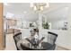 Bright dining area featuring a modern light fixture and an open view of the updated kitchen at 8088 E Via Del Valle --, Scottsdale, AZ 85258