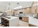 Bright kitchen with stainless steel appliances, quartz counters, skylight, and breakfast bar seating at 8088 E Via Del Valle --, Scottsdale, AZ 85258