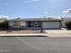 Charming single-story home with a desert landscape, arched windows, and a spacious two-car garage at 8235 E Medina Ave, Mesa, AZ 85209