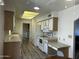 Bright kitchen features wood cabinets, laminate countertops, and white appliances at 8235 E Medina Ave, Mesa, AZ 85209