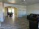 Open living room with laminate flooring and abundant natural light at 8235 E Medina Ave, Mesa, AZ 85209