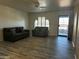 Spacious living room with wood laminate flooring and lots of natural light at 8235 E Medina Ave, Mesa, AZ 85209