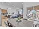 Open-concept dining area with table adjacent to kitchen and sliding glass doors to outdoor patio at 8245 E Bell Rd # 201, Scottsdale, AZ 85260