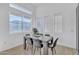 Modern dining room with gray table and chairs, bright natural light, and light-colored flooring at 8245 E Bell Rd # 201, Scottsdale, AZ 85260