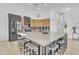 Spacious kitchen island with bar stool seating, stainless steel appliances, and modern finishes at 8245 E Bell Rd # 201, Scottsdale, AZ 85260