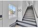 Staircase leading to the upper level features modern design and natural light from a window at 8245 E Bell Rd # 201, Scottsdale, AZ 85260