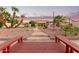 View of backyard featuring a pool, firepit, outdoor kitchen, putting green, string lights, and desert landscaping at 844 W Beechnut Dr, Chandler, AZ 85248