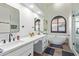 Bright bathroom featuring a sleek bathtub, white vanity with double sinks, and modern black fixtures at 844 W Beechnut Dr, Chandler, AZ 85248