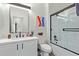 Modern bathroom featuring a glass-enclosed shower and sleek white vanity with modern fixtures at 844 W Beechnut Dr, Chandler, AZ 85248