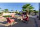 Relaxing backyard area featuring a fire pit with outdoor seating, a putting green, and luscious palm trees at 844 W Beechnut Dr, Chandler, AZ 85248