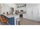 Modern white kitchen featuring stainless steel appliances, a breakfast bar, and sleek countertops at 844 W Beechnut Dr, Chandler, AZ 85248