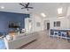 Bright open-concept living area with modern furnishings, a breakfast bar, and wood-look flooring at 844 W Beechnut Dr, Chandler, AZ 85248