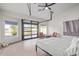 Modern main bedroom with a unique roll-up glass door to the street, and wood-look flooring at 844 W Beechnut Dr, Chandler, AZ 85248