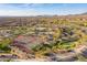 An aerial view shows a pool, clubhouse, tennis courts, and putting green for the community to enjoy at 8525 E Lynwood St, Mesa, AZ 85207