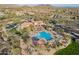 An aerial view of the community recreation center, pool, tennis court, and parking area at 8525 E Lynwood St, Mesa, AZ 85207