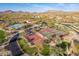 Aerial shot of the community showcasing a pool, multiple tennis courts and a basketball court with mountain views at 8525 E Lynwood St, Mesa, AZ 85207