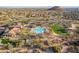 Aerial view of the recreation center, with a community pool, tennis courts, and grassy park at 8525 E Lynwood St, Mesa, AZ 85207