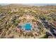 Aerial view of a resort style pool, surrounded by desert landscaping and several shade ramadas at 8525 E Lynwood St, Mesa, AZ 85207