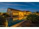 Backyard at dusk showcasing a pool, desert landscaping and patio furniture at 8525 E Lynwood St, Mesa, AZ 85207