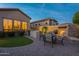 Outdoor kitchen and dining area featuring a built-in barbeque and fireplace at 8525 E Lynwood St, Mesa, AZ 85207