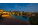 Backyard at dusk featuring pool, spa, desert landscaping and brick pavers at 8525 E Lynwood St, Mesa, AZ 85207