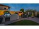 Backyard outdoor kitchen, barbeque, fireplace, dining area and synthetic grass at 8525 E Lynwood St, Mesa, AZ 85207