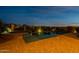 Backyard at dusk featuring pool, spa, brick pavers and desert landscaping at 8525 E Lynwood St, Mesa, AZ 85207