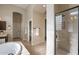 Spacious bathroom featuring a soaking tub, glass shower, and dual sinks with dark wood cabinets at 8525 E Lynwood St, Mesa, AZ 85207