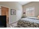 Bedroom with twin beds, sliding closet, and a view to the outside at 8525 E Lynwood St, Mesa, AZ 85207