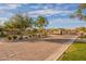 A paved entrance to the community is guarded by beautiful stone buildings and a gate for added security at 8525 E Lynwood St, Mesa, AZ 85207