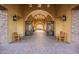 Elegant courtyard with stone arches, wrought iron gates, and comfortable wooden benches at 8525 E Lynwood St, Mesa, AZ 85207