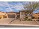 Charming stucco and stone home featuring a tile roof, desert landscaping, and an attached two-car garage at 8525 E Lynwood St, Mesa, AZ 85207