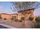 Attractive home with a paved driveway and desert landscaping, complemented by a mature tree for added shade at 8525 E Lynwood St, Mesa, AZ 85207