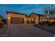 Night shot of the home's exterior showing the driveway, garage and front entrance at 8525 E Lynwood St, Mesa, AZ 85207