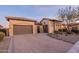 Charming home with a paved driveway, well-manicured landscaping, and a welcoming two-car garage at 8525 E Lynwood St, Mesa, AZ 85207