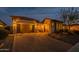 Exterior of home featuring a three-car garage and desert landscaping at 8525 E Lynwood St, Mesa, AZ 85207