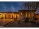 Beautiful home exterior featuring a three-car garage and desert landscaping at 8525 E Lynwood St, Mesa, AZ 85207