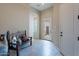 Inviting foyer with tiled flooring, a wooden bench with decorative pillows, and a well-lit hallway at 8525 E Lynwood St, Mesa, AZ 85207