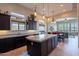 Open kitchen with sleek countertops, pendant lighting, and a large island with bar seating at 8525 E Lynwood St, Mesa, AZ 85207