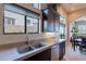 Bright kitchen featuring a stainless steel sink, a window with a view, and dark wood cabinets at 8525 E Lynwood St, Mesa, AZ 85207