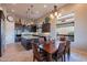 Elegant kitchen with dark wood cabinets, stainless steel appliances, and a dining table at 8525 E Lynwood St, Mesa, AZ 85207