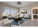 Bright living room featuring tile floors, a ceiling fan, plush seating, and stylish decor at 8525 E Lynwood St, Mesa, AZ 85207