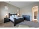 Comfortable main bedroom with a large bed, neutral tones, and natural light from the window at 8525 E Lynwood St, Mesa, AZ 85207