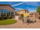 Inviting outdoor space with a stone fireplace, grill, and cozy seating area, perfect for entertaining at 8525 E Lynwood St, Mesa, AZ 85207