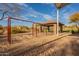 A colorful playground with swings, play structure, and shaded seating for parents at 8525 E Lynwood St, Mesa, AZ 85207