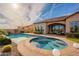 Gorgeous backyard featuring a sparkling pool, inviting spa, and meticulously landscaped surroundings at 8525 E Lynwood St, Mesa, AZ 85207