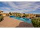 Expansive backyard oasis with a sparkling pool, lush landscaping, and a serene desert backdrop at 8525 E Lynwood St, Mesa, AZ 85207